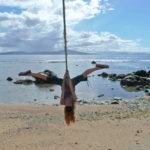 Sandrine's acrobatic straddle - Taveuni Island, Fiji As Sandrine practices in her "silks" she felt right at home straddling the dateline on this rope placed exactly on the 180th meridian of longitude. I guess if she were in Greenwich, England, she'd be right side up!